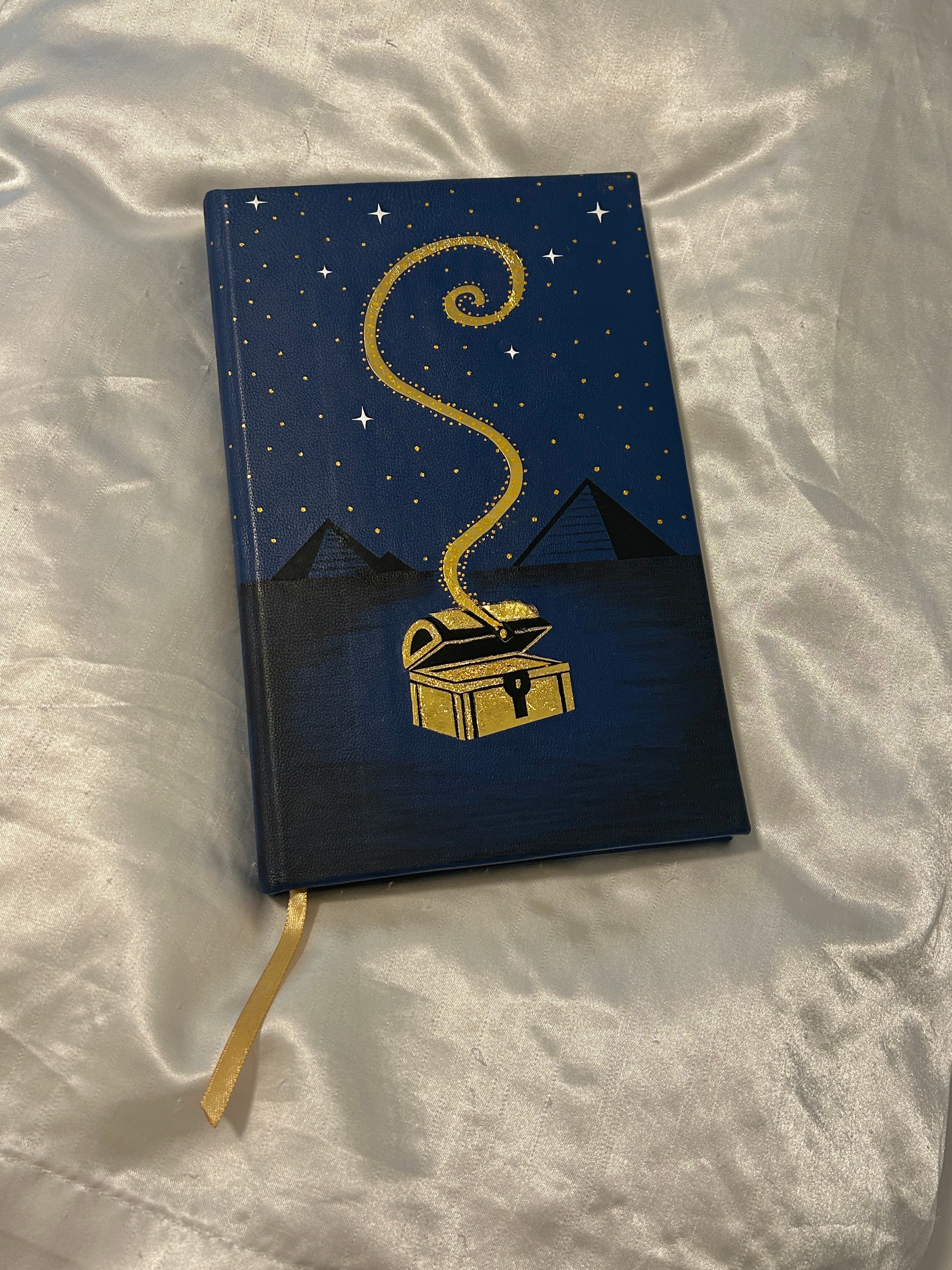 Blue, black, and gold marbled endpapers inside The Alchemist edition