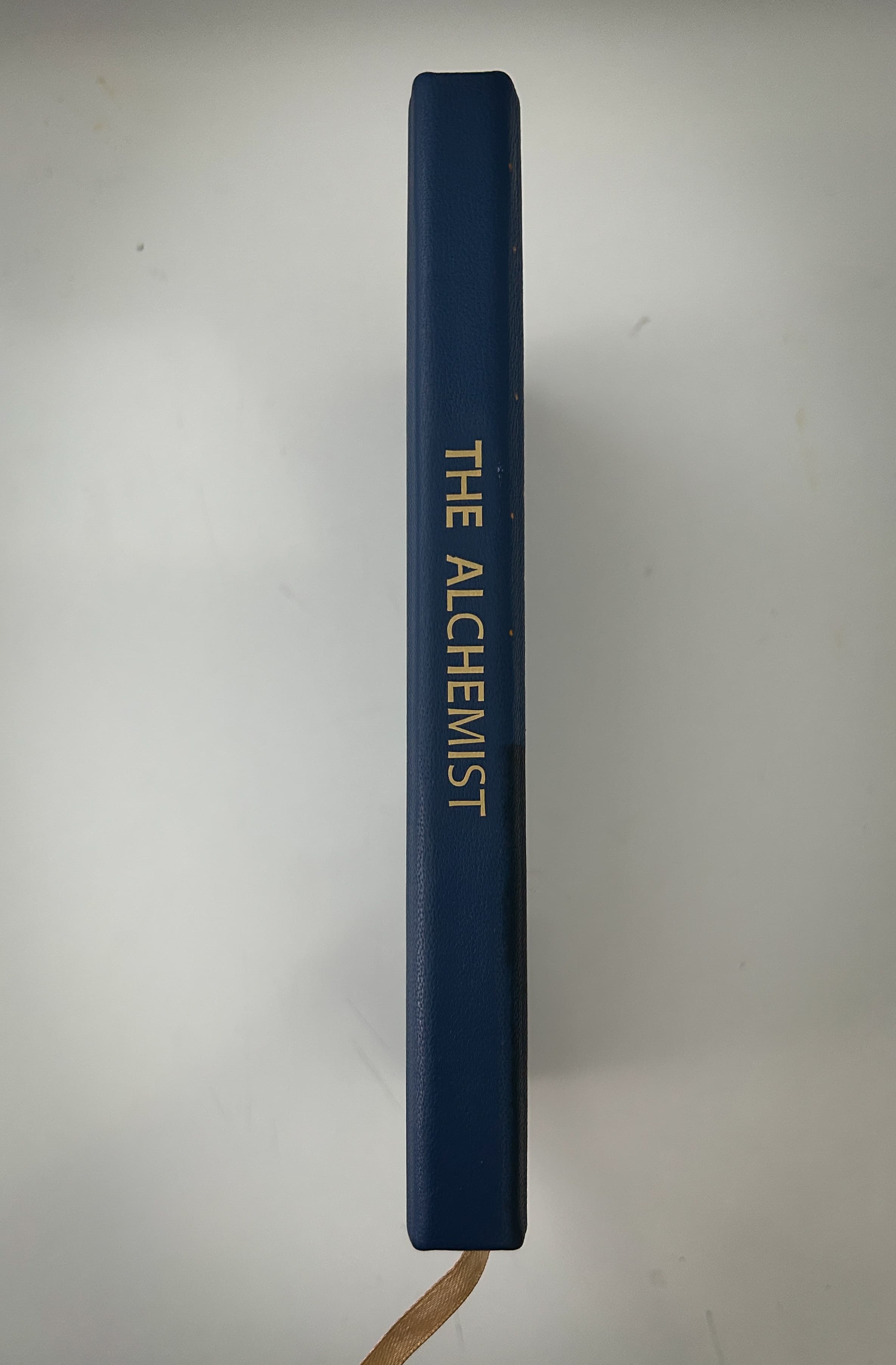Gold-detailed spine of The Alchemist edition
